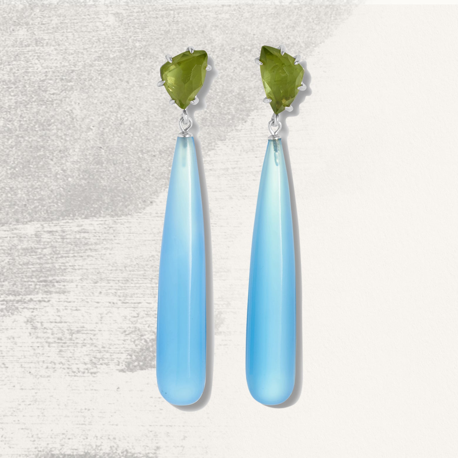 Earrings with green peridot above long blue chalcedony