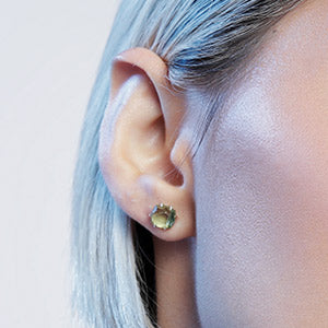 Close up woman wearing Green peridot stud earrings