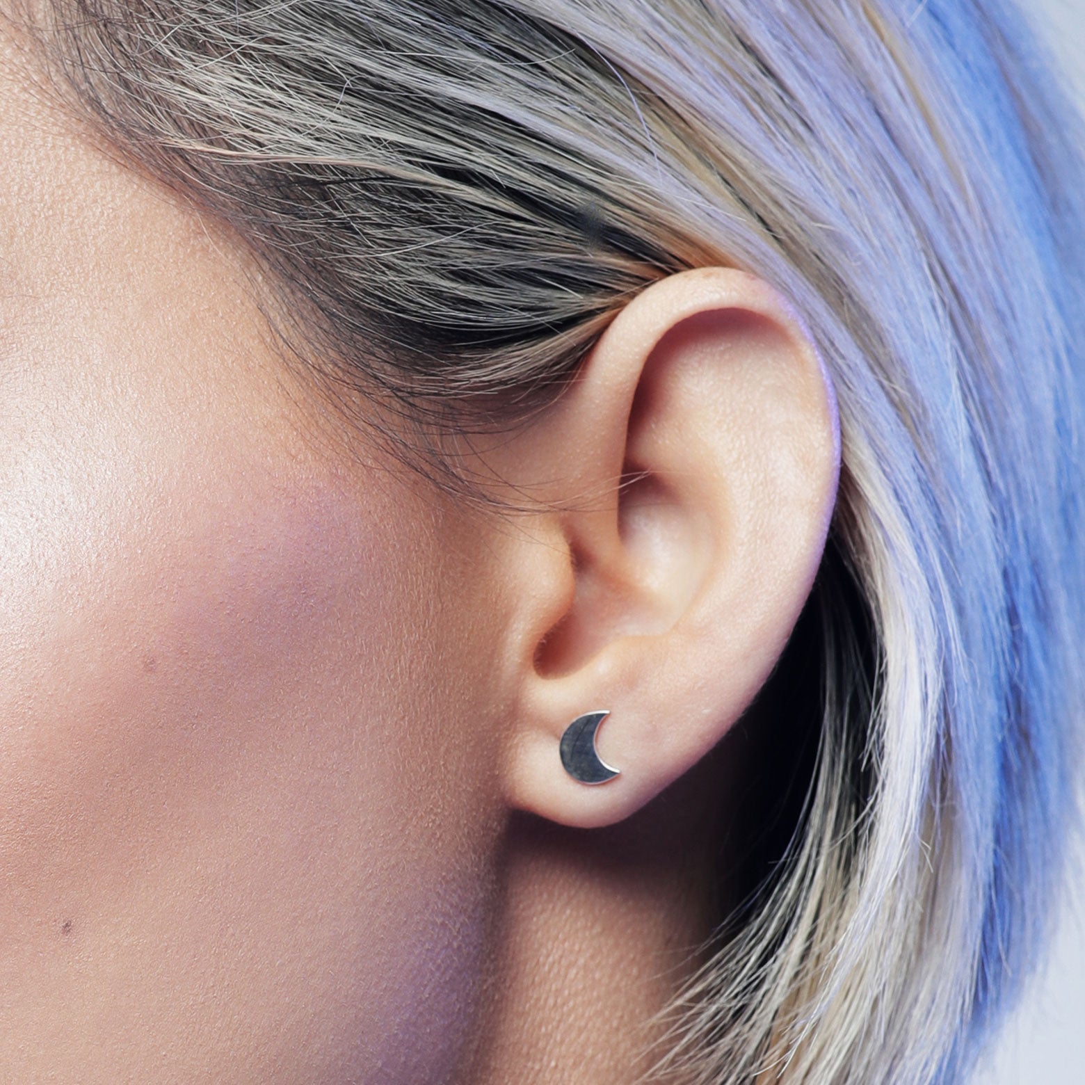 Close up woman wearing sterling silver crescent moon stud earrings