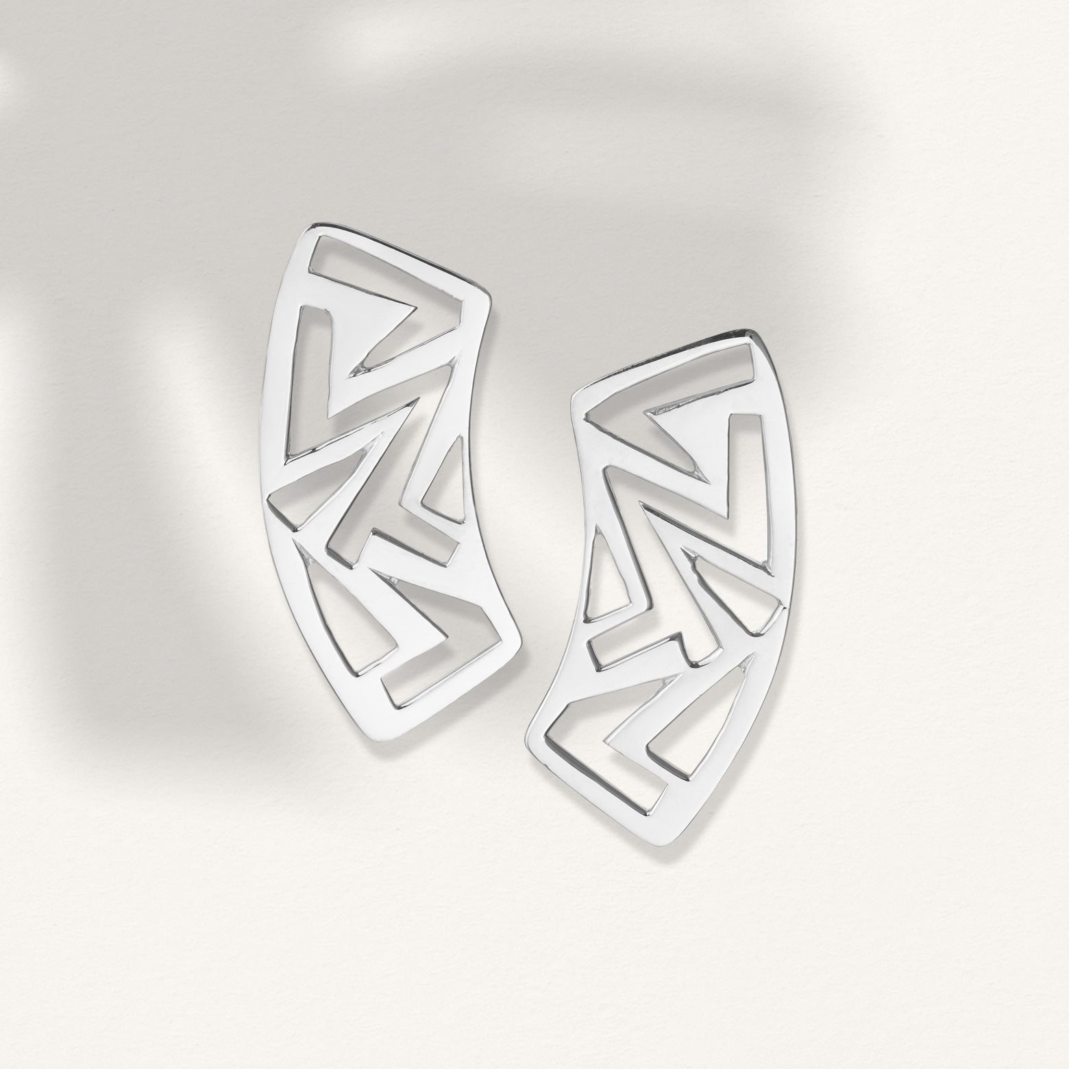 Kelly Woodcroft Jeweller handcrafted silver treetop canopy earrings feature geometric shapes and curved edges. 