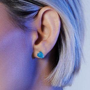Close up woman wears Neon blue apatite stud earrings