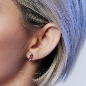 Close up woman wearing Violet garnet stud earrings